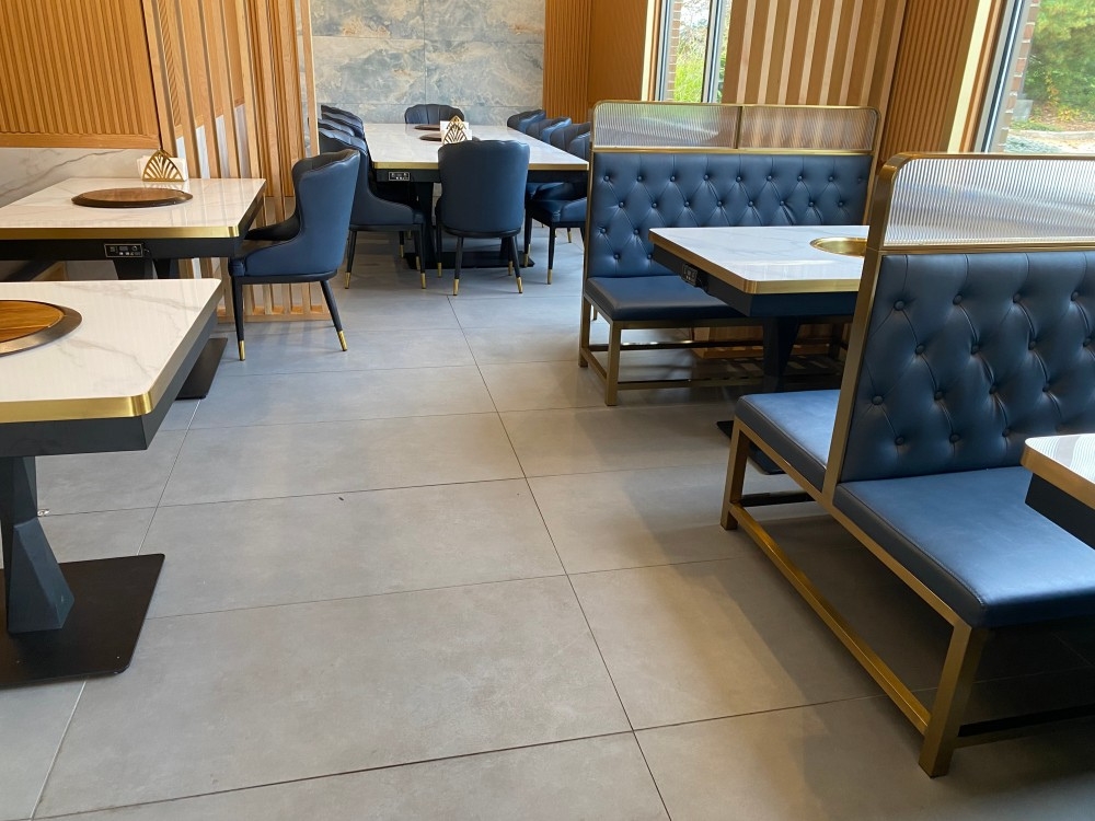 Dining space with hot pot tables, blue chairs, stylish decor at Pho Wayne, a Vietnamese Restaurant in Berwyn