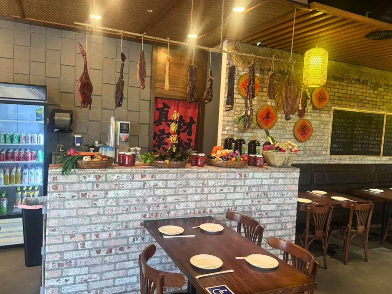Bar counter with cured meat decor and beverage fridge at Picky Hunan, a Hunan Restaurant in Alhambra