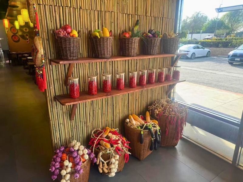 Baskets of vegetables and chili jars by the window at Picky Hunan, a Hunan Restaurant in Alhambra