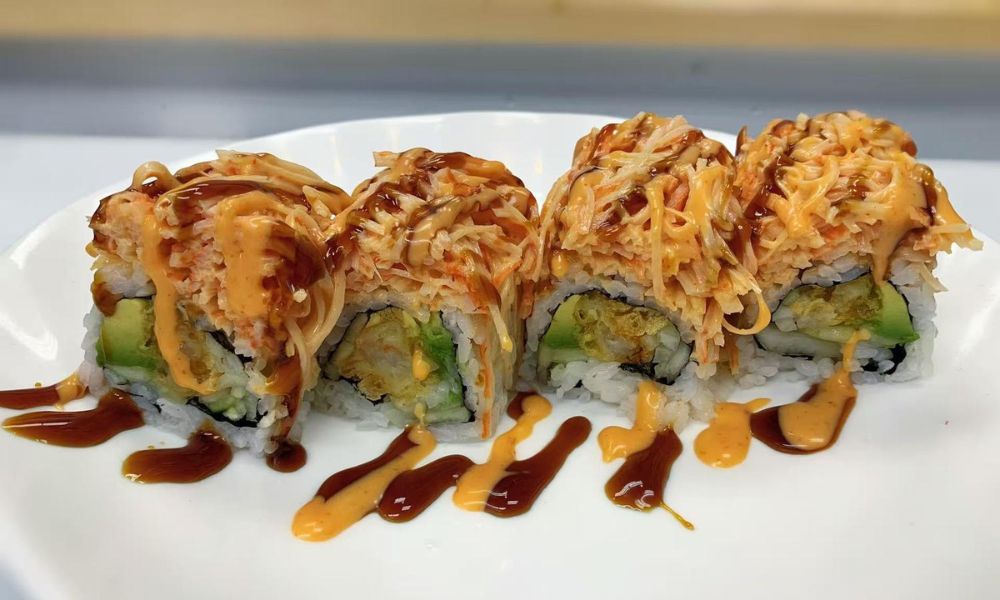 Sushi roll with crab, avocado, and spicy sauces at Poke 46, a Japanese Restaurant in Pine Brook