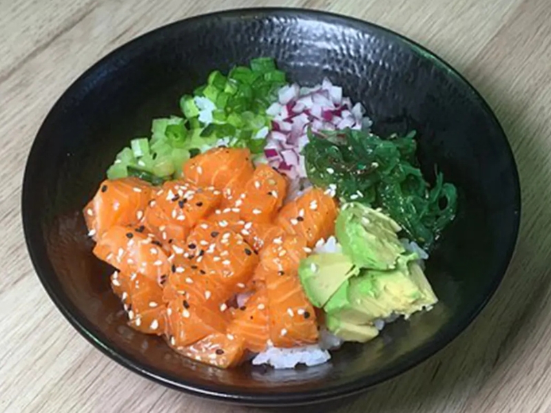 Salmon poke bowl with avocado, seaweed, and green onions at Poke Bowl, an Hawaiian Restaurant in Algonquin