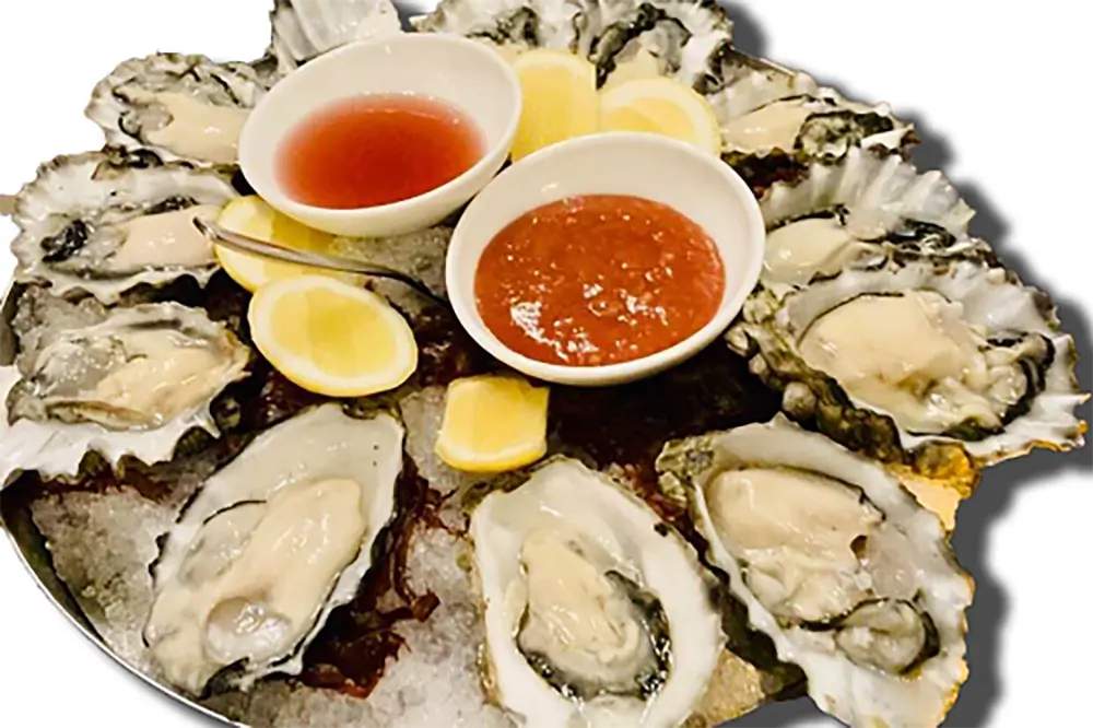 Fresh raw oyster platter with sauces and lemon at Poke Fresh, a Poke bar in Houston