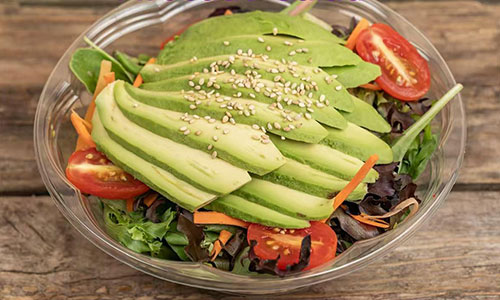 Fresh avocado salad with mixed greens, cherry tomatoes, carrots, and sesame seeds at Poke House Huntington, a Hawaiian restaurant in Huntington