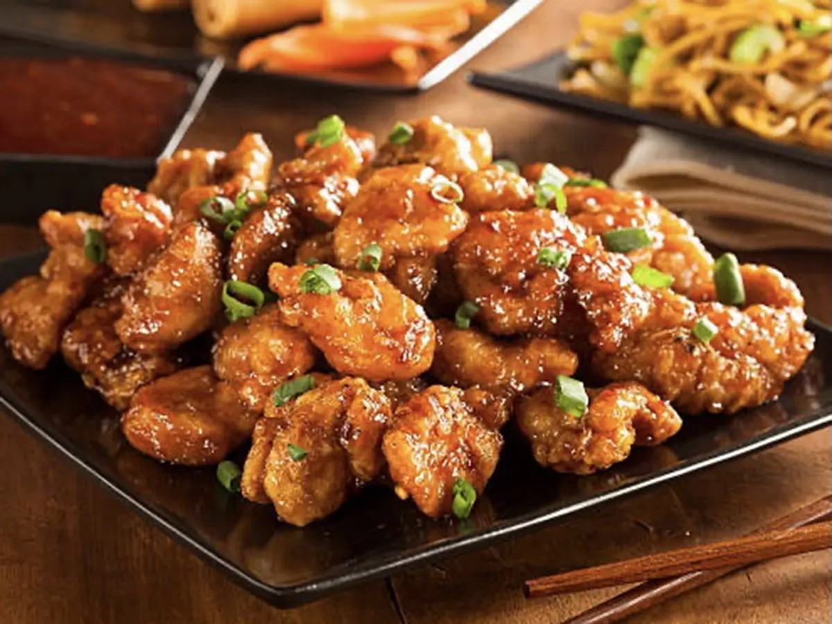 Pokéloha-Asian-Fusion-Restaurant-Orange-Chicken-KS Crispy orange chicken garnished with green onions at Pokéloha, a Asian Fusion Restaurant in Woonsocket