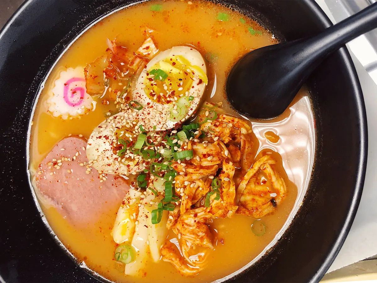 Pokéloha-Asian-Fusion-Restaurant-Ramen-Noodles-KS Ramen bowl with egg, meat, and garnished with sesame seeds and scallions at Pokéloha, a Asian Fusion Restaurant in Woonsocket
