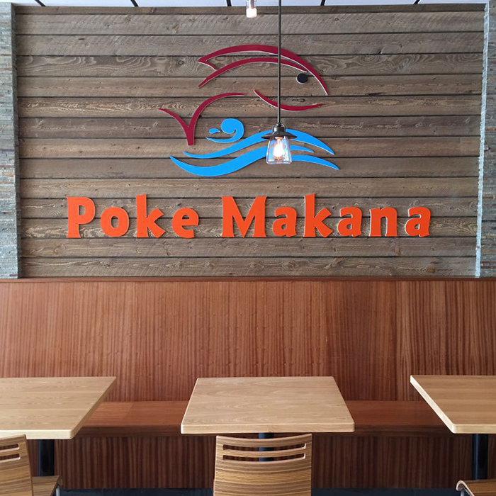 Assorted poke bowl toppings including corn, edamame, mango, and avocado in clear containers at Poke Makana, a Hawaiian restaurant in Sherwood