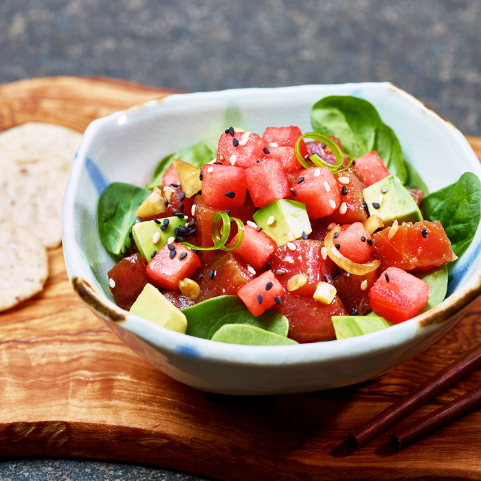 Tuna poke salad with avocado, spinach, sesame seeds, and green onion served in a ceramic bowl at Poke Makana, a Hawaiian restaurant in Sherwood