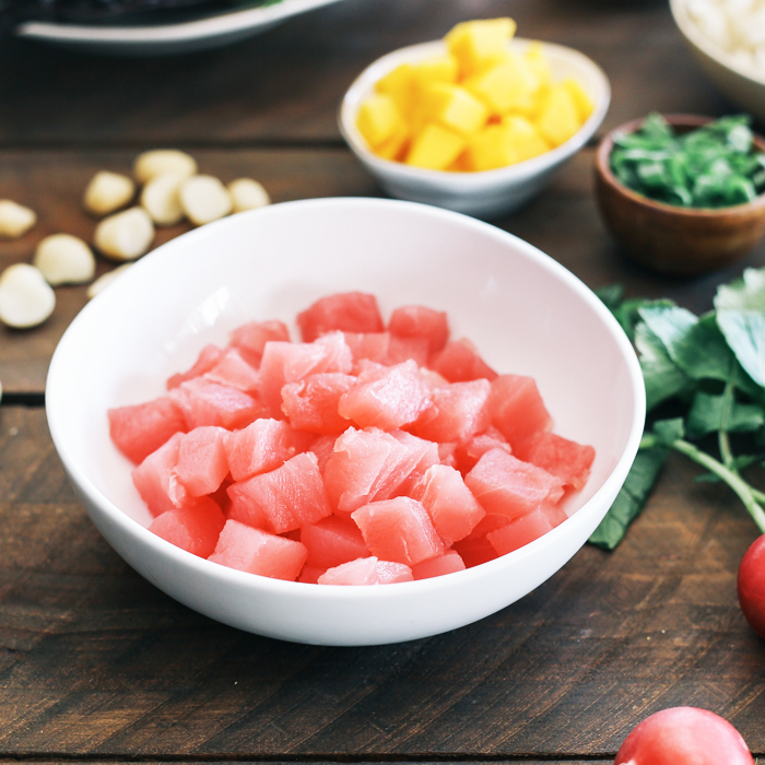 Fresh cubed raw ahi tuna in a white bowl, prepared as the main ingredient for poke bowls at Poke Makana, a Hawaiian restaurant in Sherwood