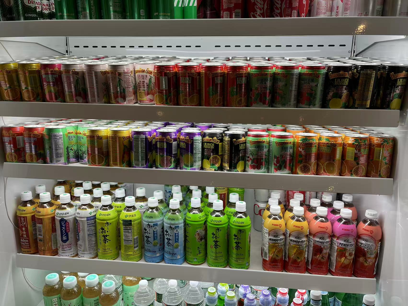 Poke-One-Poke-Bowl-Restaurant-Morris-Plains Refrigerator stocked with assorted canned and bottled Asian teas and beverages.