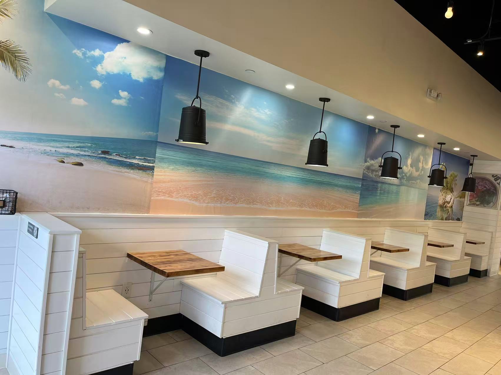 Poke-One-Poke-Bowl-Restaurant-Morris-Plains Interior dining area with beach mural, white booths, and wooden tables.