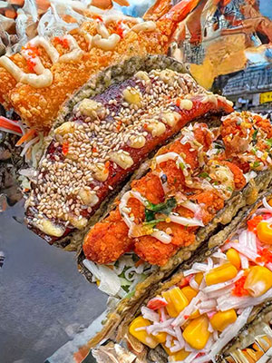 Assorted sushi tacos with shrimp, eel, chicken, and veggie fillings