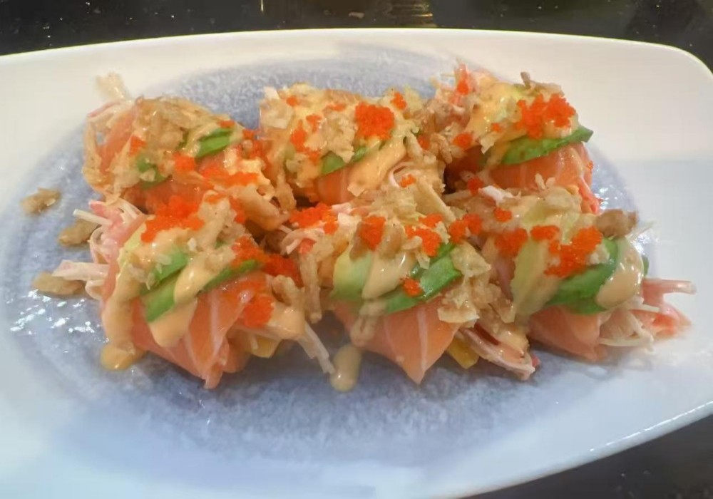 Salmon avocado roll with fish roe, crispy bits, and spicy sauce at Poke Zone, a Japanese Restaurant in Edgewater