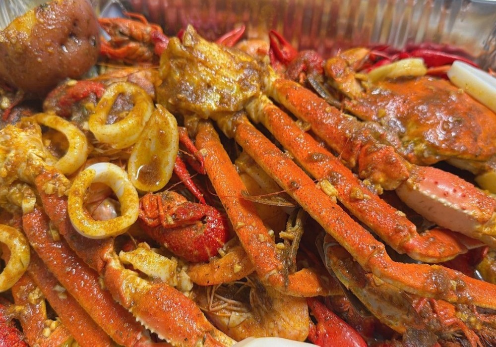 Spicy seafood boil with snow crab, crawfish, and squid rings at Poke Zone, a Japanese Restaurant in Edgewater
