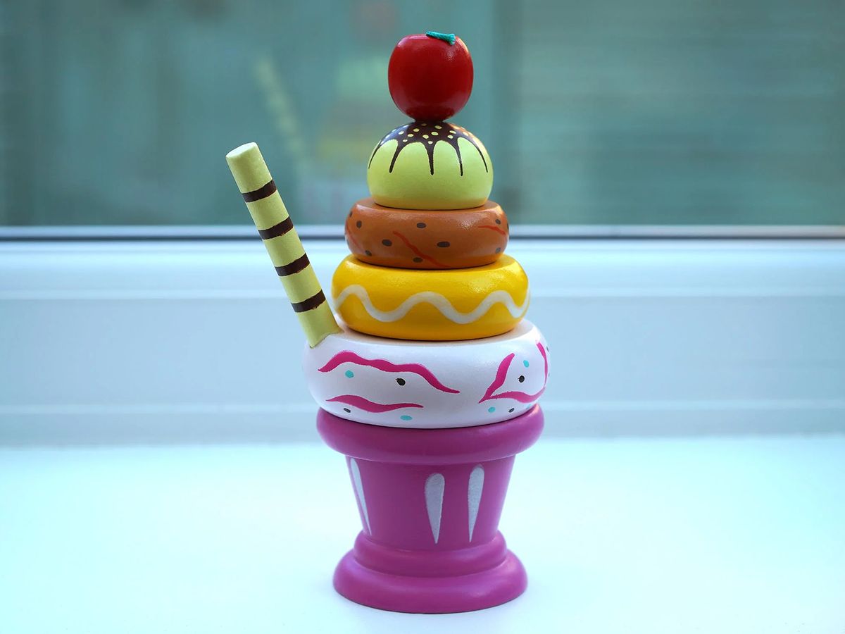Colorful wooden toy ice cream sundae stack by a window at Pop Onigiri, a Dessert Shop in Bonita Springs