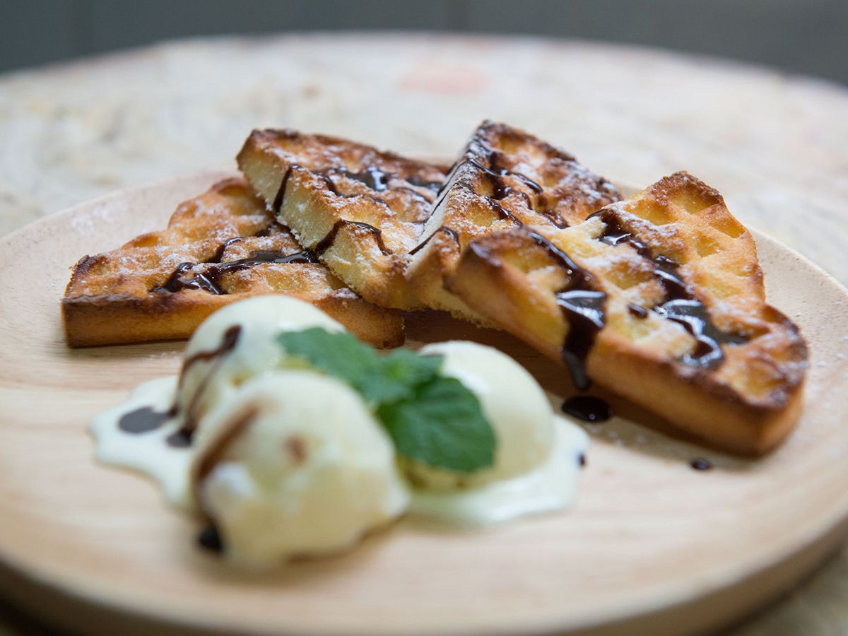 Golden French toast sticks with ice cream, chocolate drizzle, and mint at Pop Onigiri, a Dessert Shop in Bonita Springs