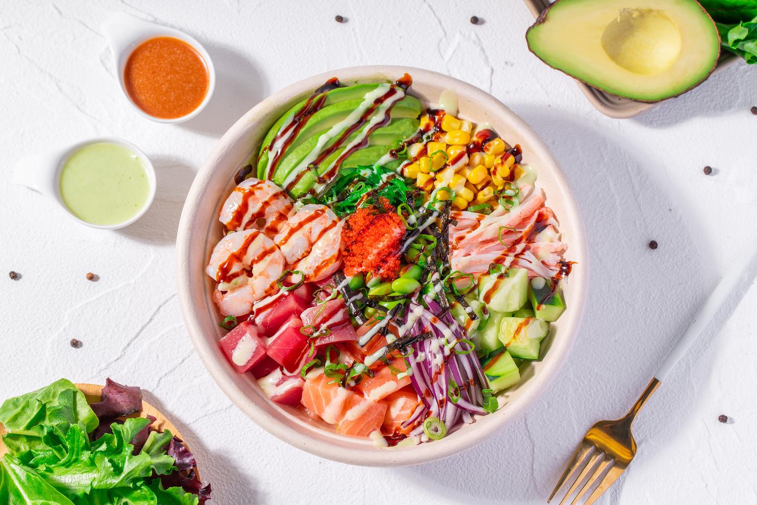Mixed seafood poke bowl with shrimp, tuna, salmon, avocado, corn and sauces at Pop Ice Cream, a Dessert Shop restaurant in Bonita Springs