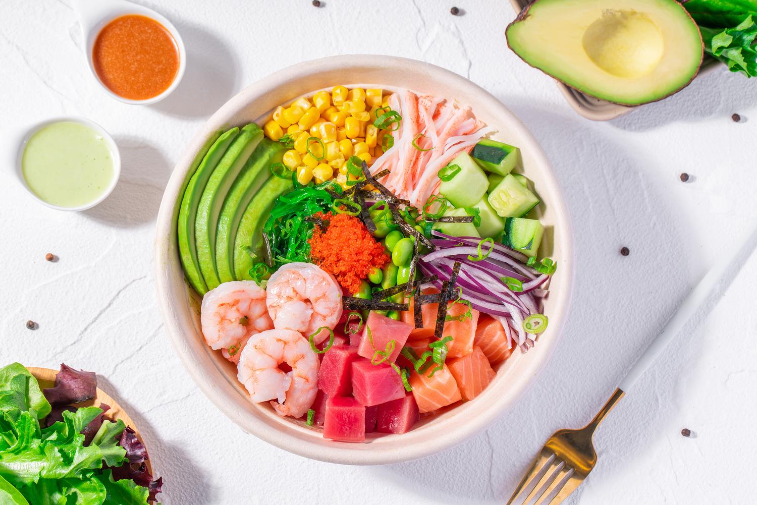 Seafood poke bowl with shrimp, tuna, salmon, avocado, edamame and colorful toppings at Pop Ice Cream, a Dessert Shop restaurant in Bonita Springs
