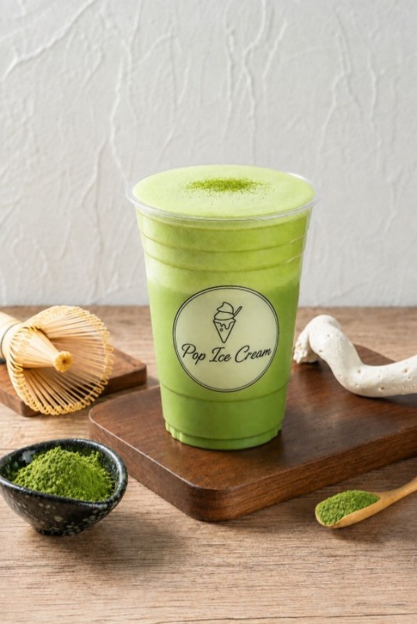 Creamy matcha beverage topped with matcha powder