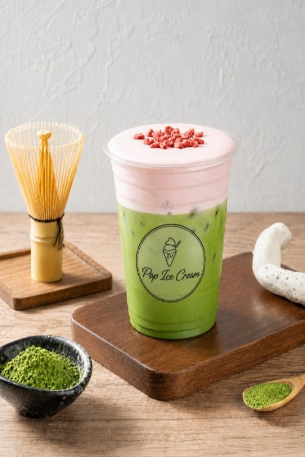 Matcha drink with pink foam and dried strawberry bits