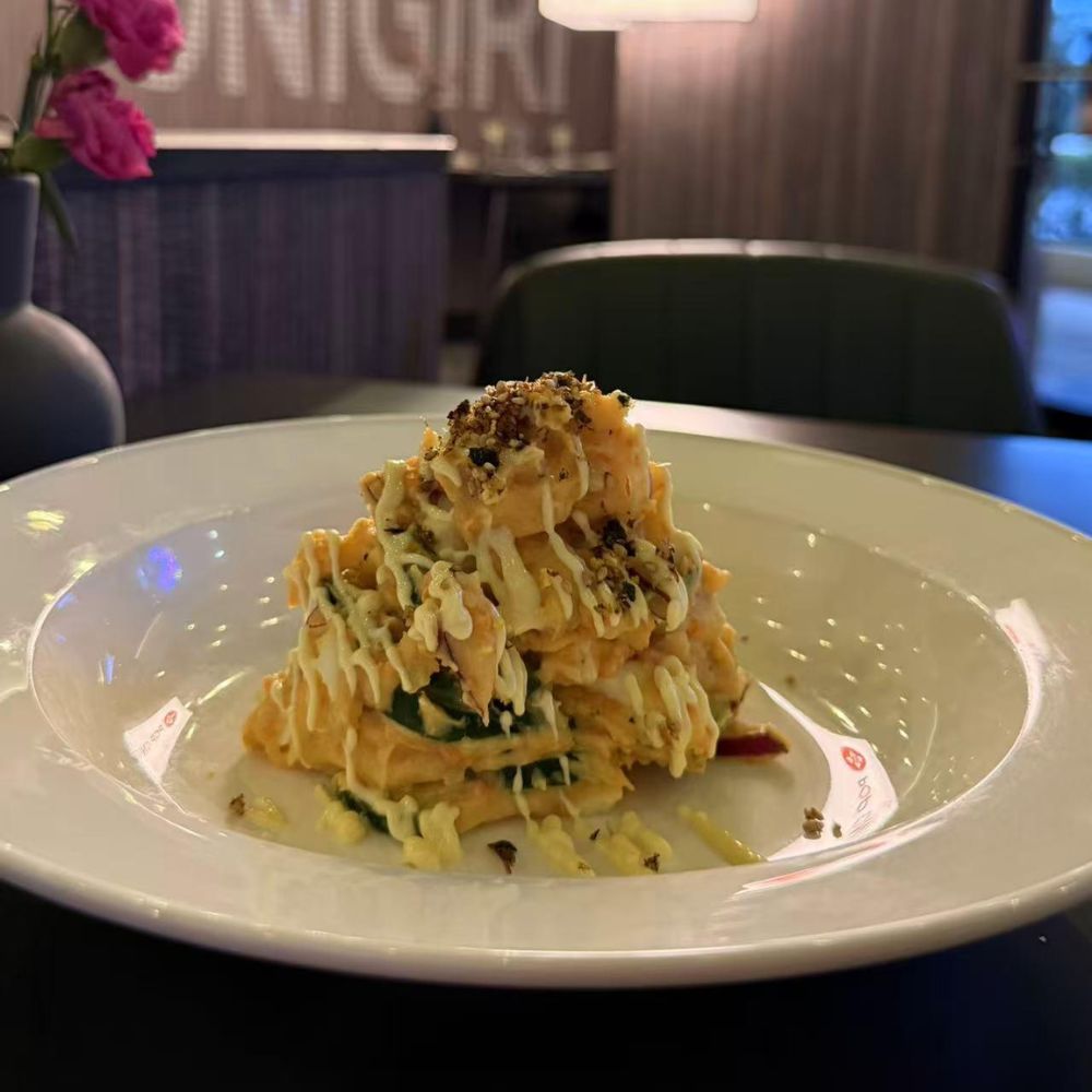 Creamy pasta stack with drizzled sauce at Pop Onigiri, a Japanese Restaurant in Bonita Springs