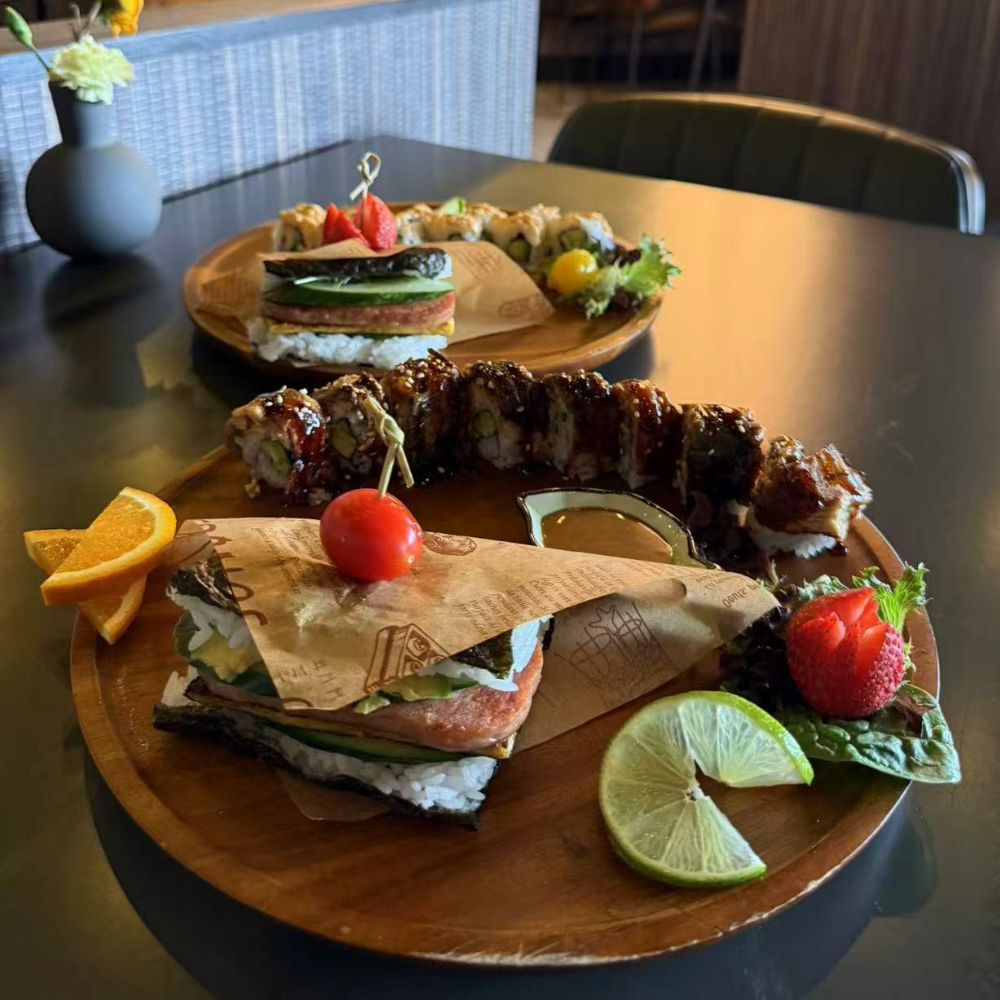 Rice sandwich and sushi platter with fruits at Pop Onigiri, a Japanese Restaurant in Bonita Springs