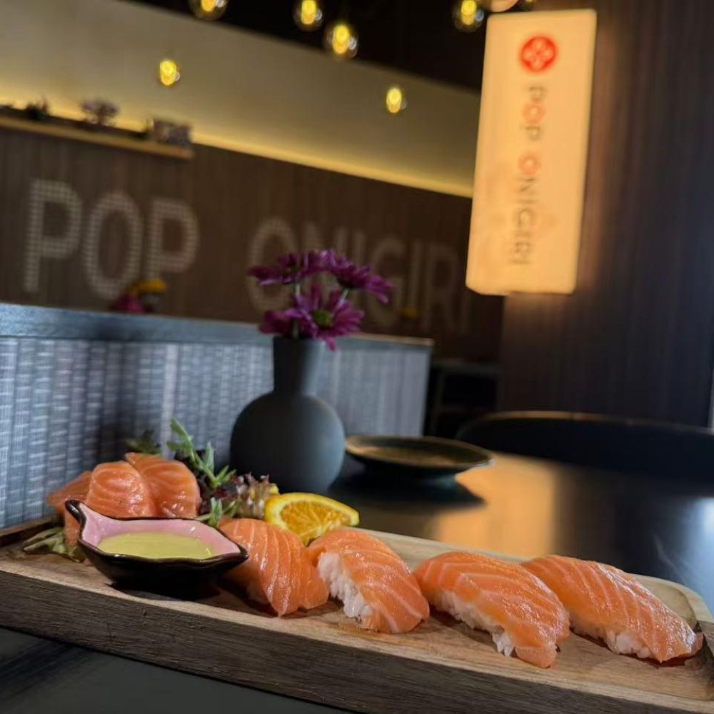 Fresh salmon nigiri with sauce at Pop Onigiri, a Japanese Restaurant in Bonita Springs
