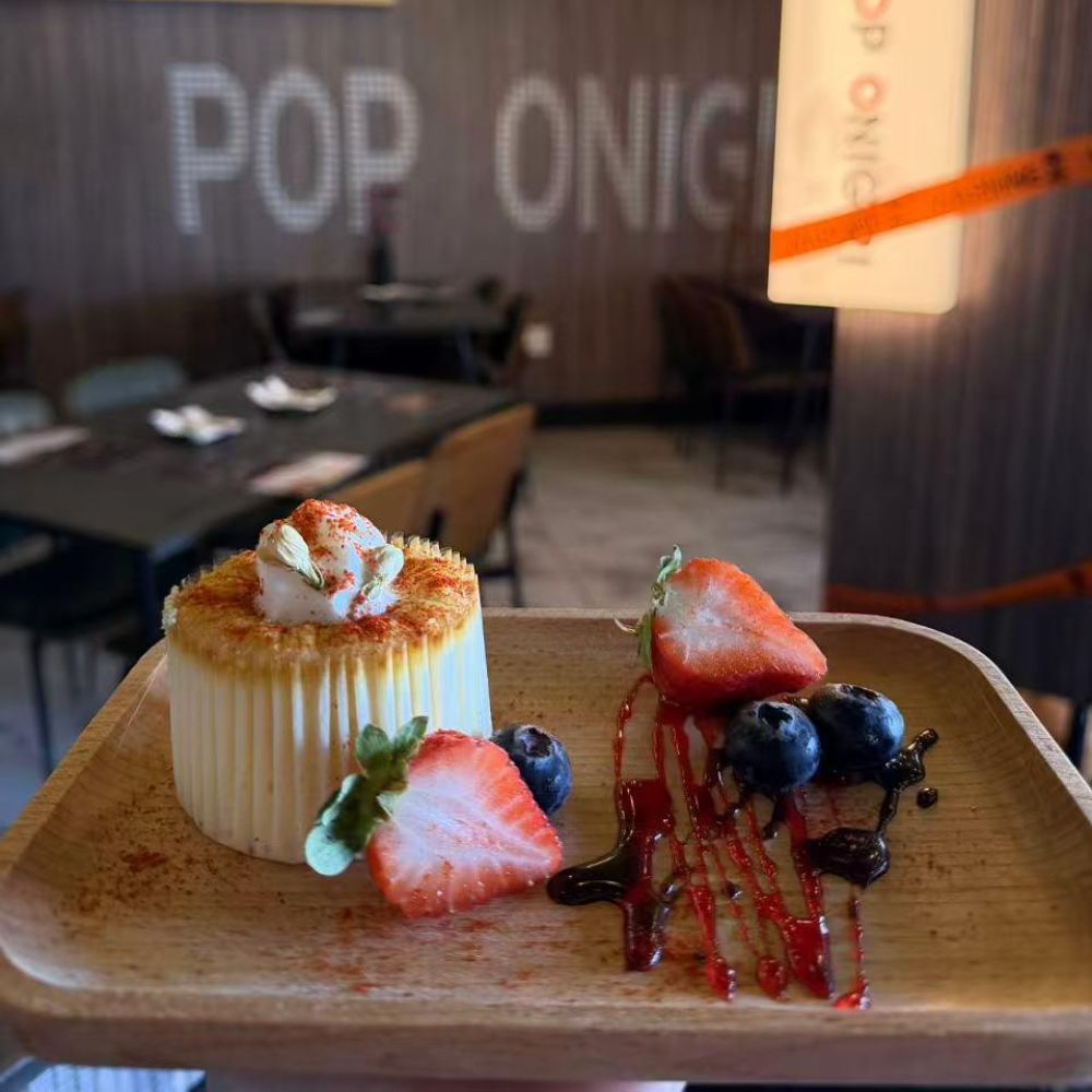 Layered mille crepe cake with fresh fruits and honey drizzle at Pop Onigiri, a Japanese Restaurant in Bonita Springs