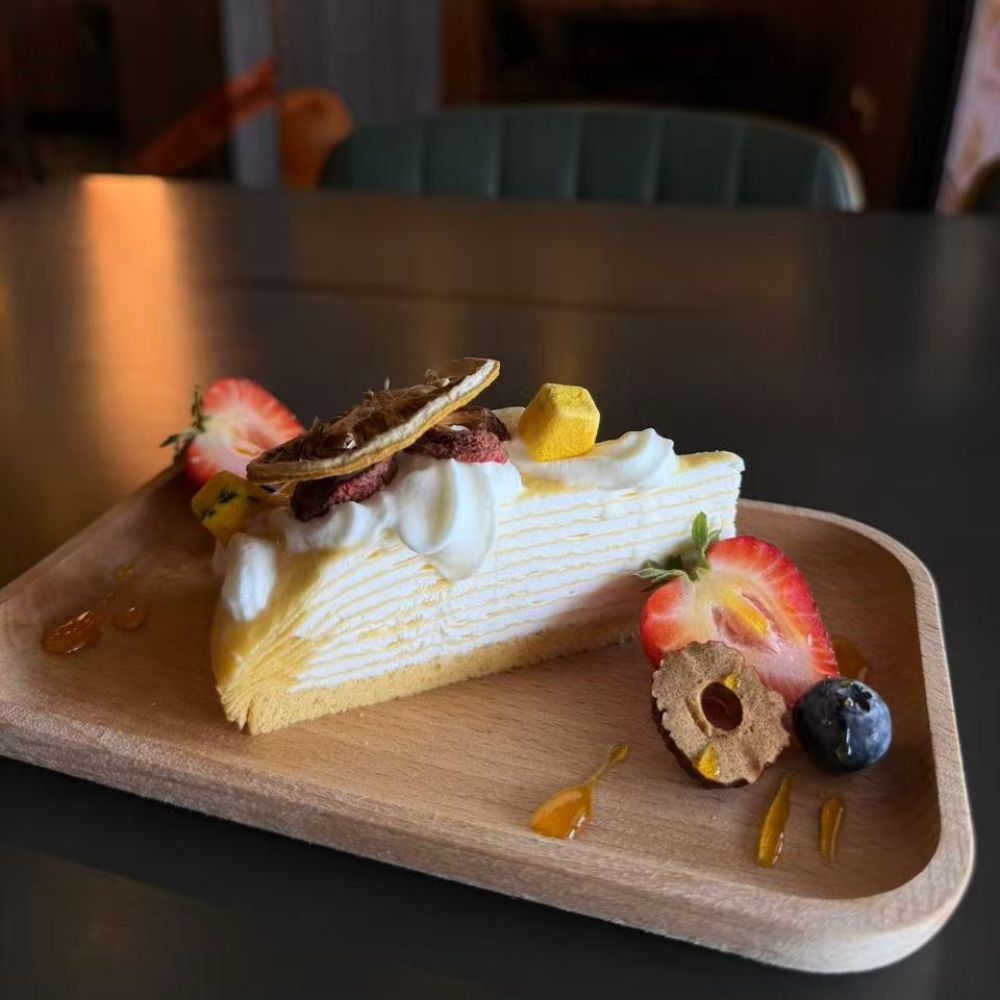 Creamy cheesecake with strawberry and blueberry accompaniment at Pop Onigiri, a Japanese Restaurant in Bonita Springs