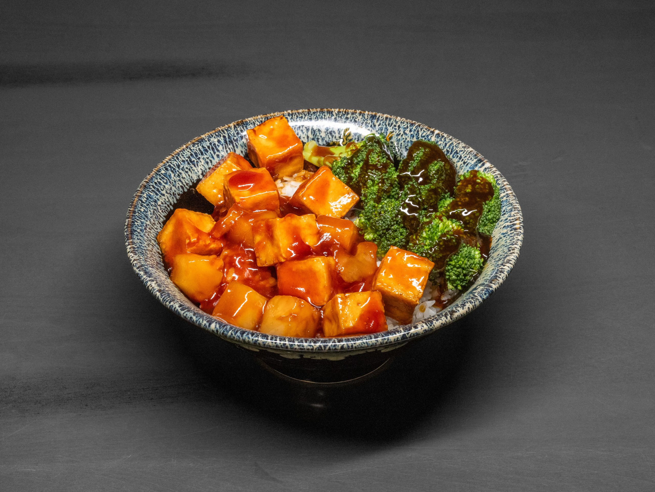 Glazed tofu over rice with broccoli at Pop Onigiri, a Japanese Restaurant in Bonita Springs