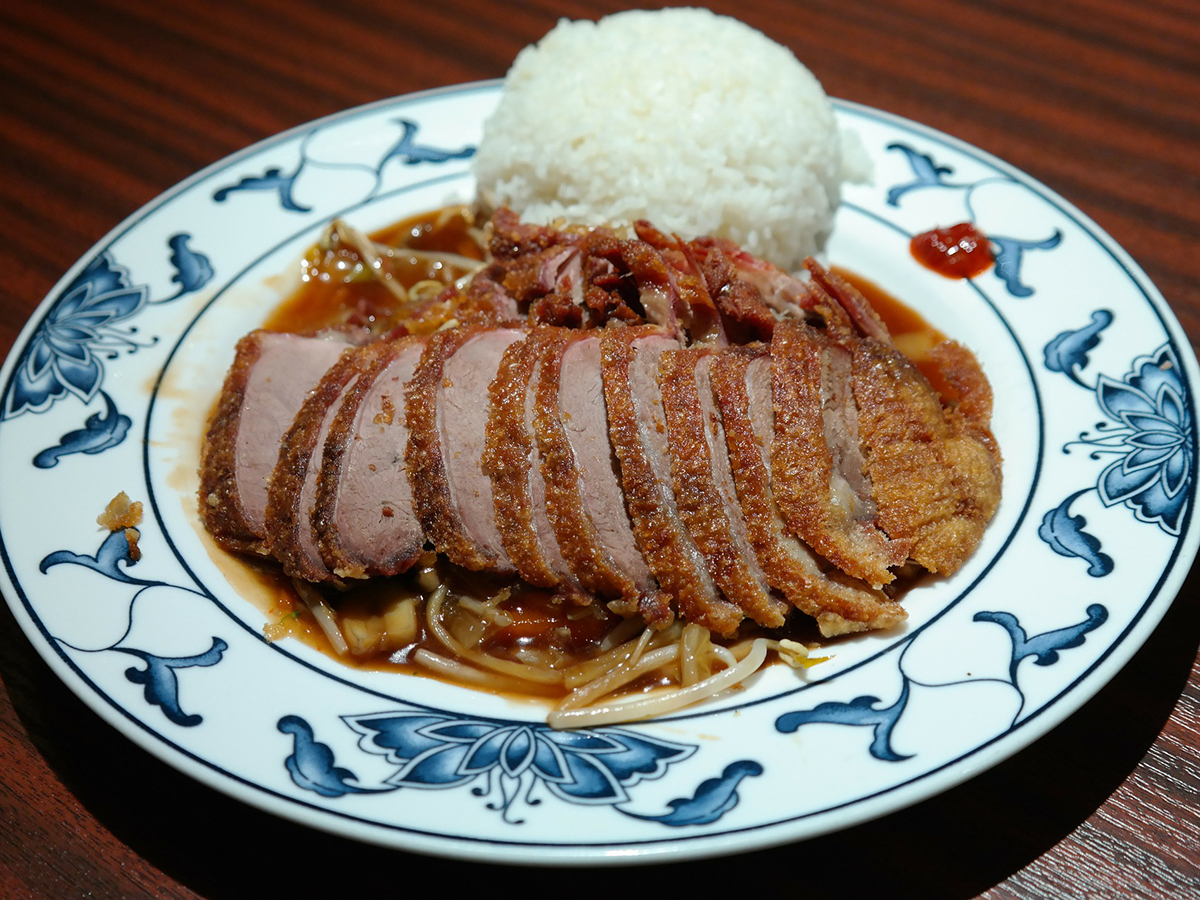 Crispy fried duck slices served with rice and bean sprouts at Precious, a Chinese Restaurant in Austin