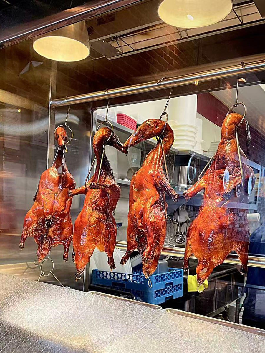 Roasted ducks hanging in the kitchen window display at Precious, a Chinese Restaurant in Austin