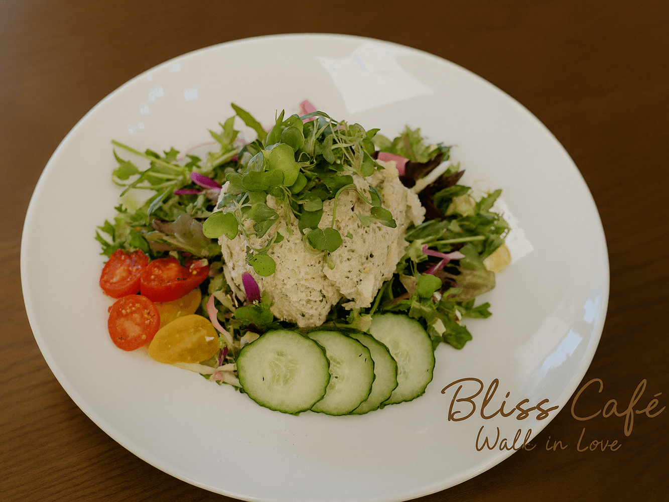 Chicken salad with mixed greens, cucumbers and cherry tomatoes at Bliss Café, a Coffee Shop in Oviedo