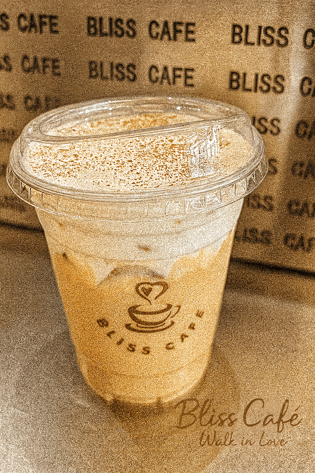 Iced specialty coffee sprinkled with cocoa powder at Bliss Café, a Coffee Shop in Oviedo