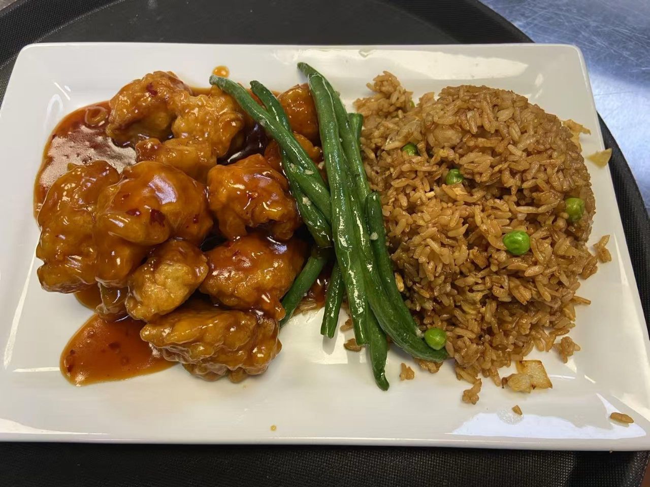 General Tso's chicken with rice and beans at Py Kitchen, a Asian Fusion Restaurant in Browns Mills