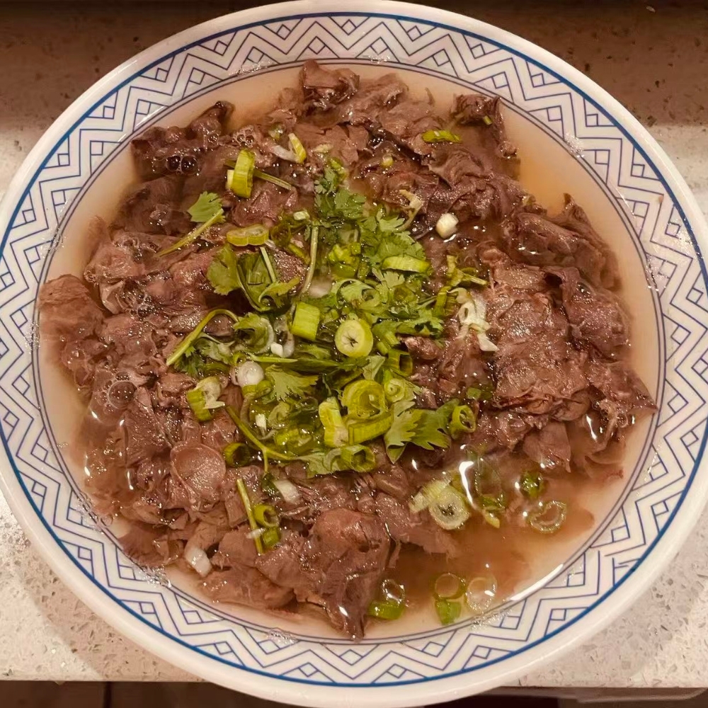 Qilu-Beef-Soup-Chinese-Restaurant-Beef-Soup-Houston Tender beef slices in clear, savory soup at Qilu Beef Soup, a Chinese Restaurant in Houston.