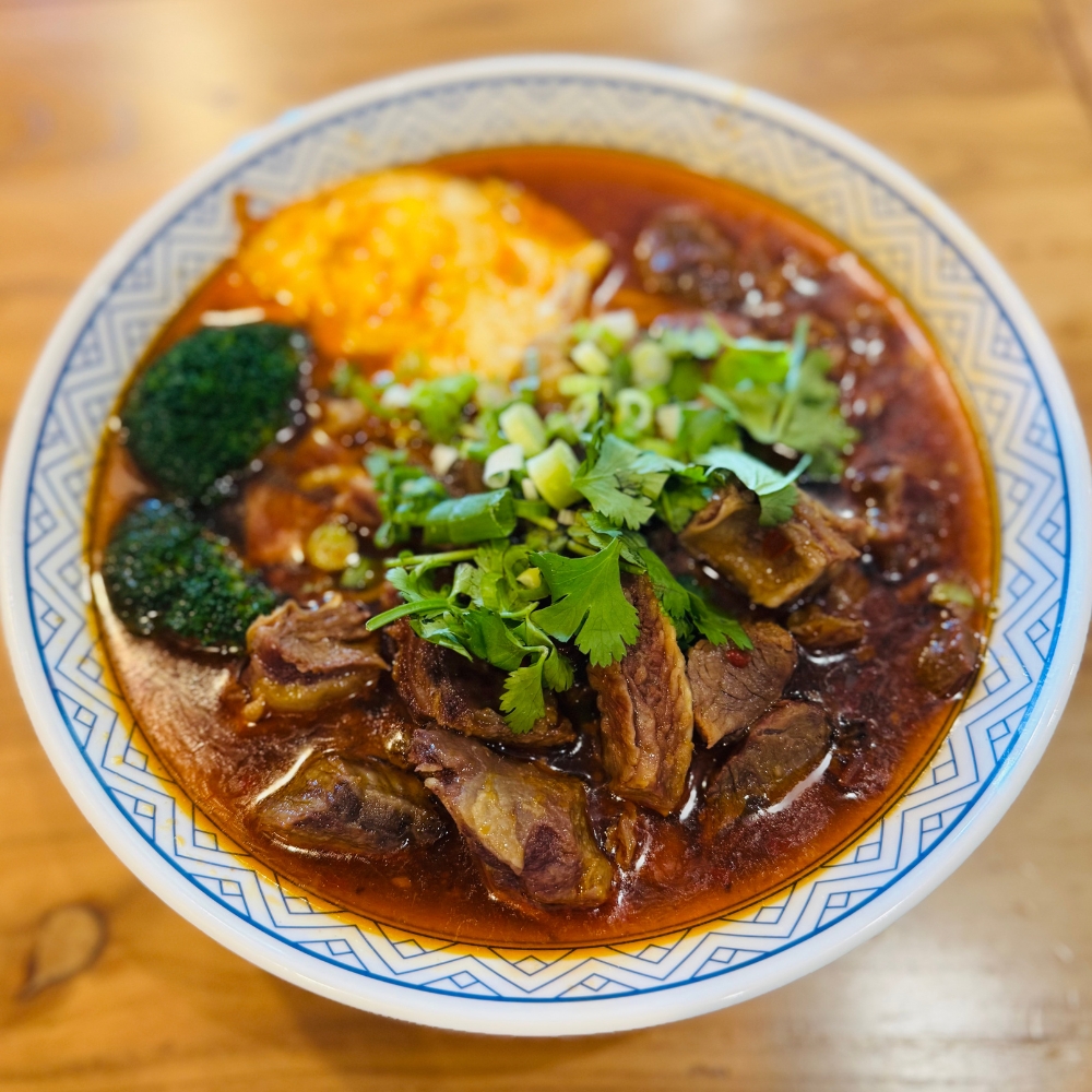 Qilu-Beef-Soup-Chinese-Restaurant-Signature-Braised-Beef-Noodles-Houston Signature braised beef chunks with noodles in red broth at Qilu Beef Soup, a Chinese Restaurant in Houston.