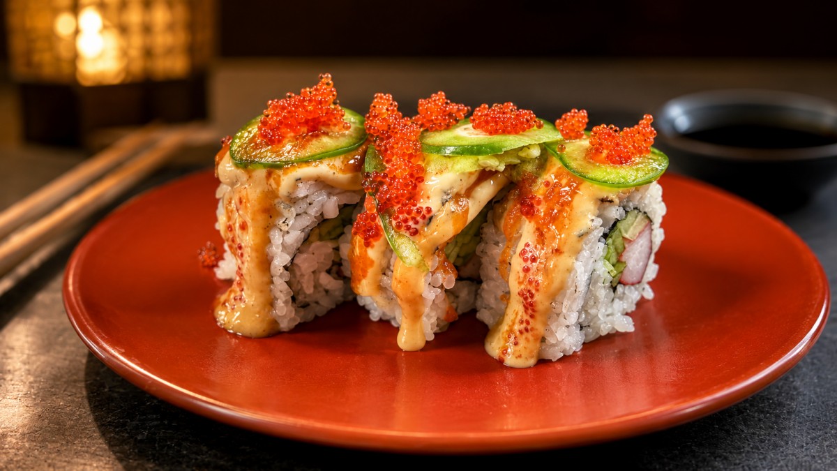 Shrimp cucumber sushi roll spicy cream tobiko red ceramic round plate at Q Korean BBQ & Revolving Sushi Restaurant in Huntsville