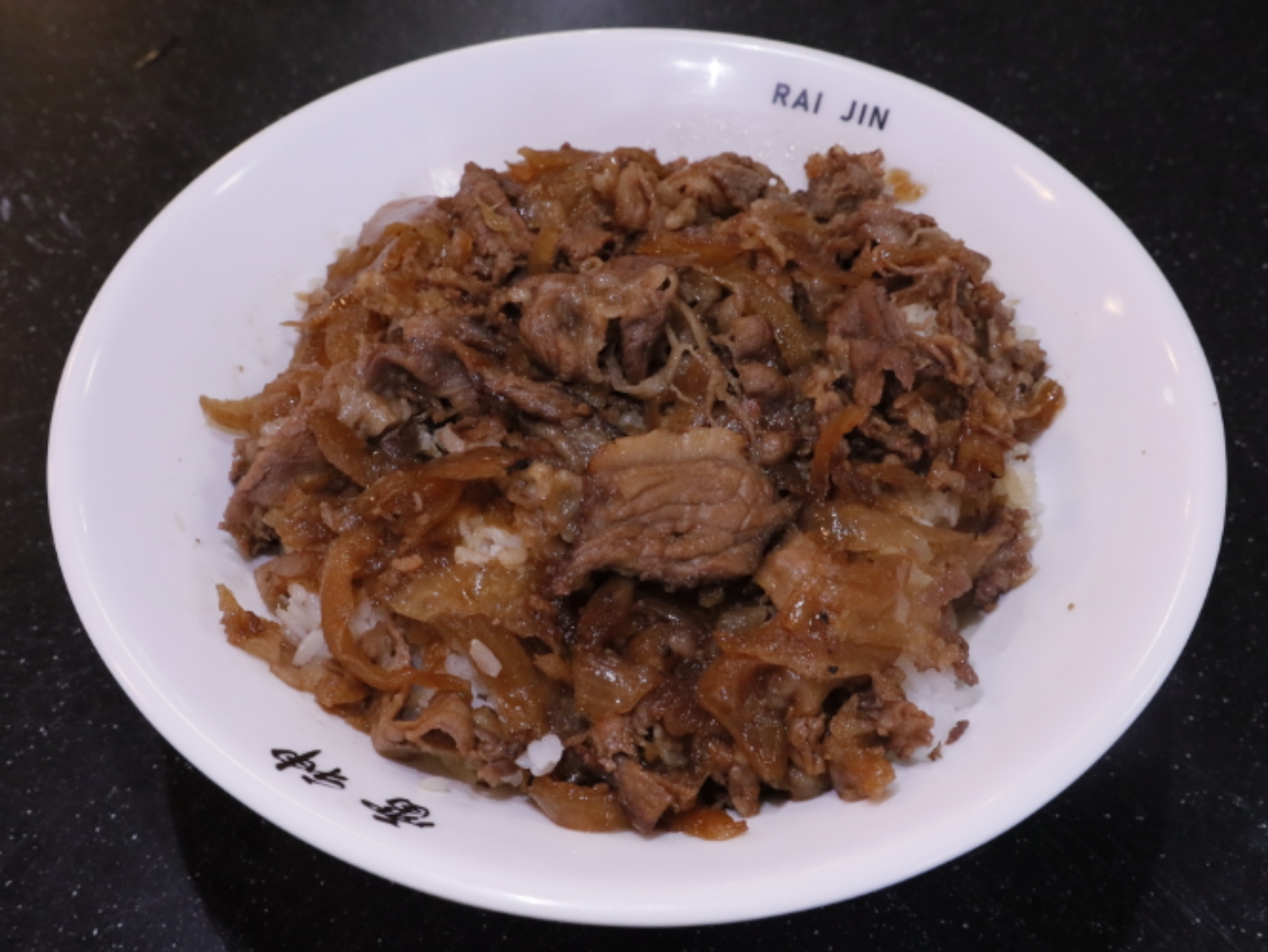 Tender beef over rice. a Ramen Restaurant in Lincoln.