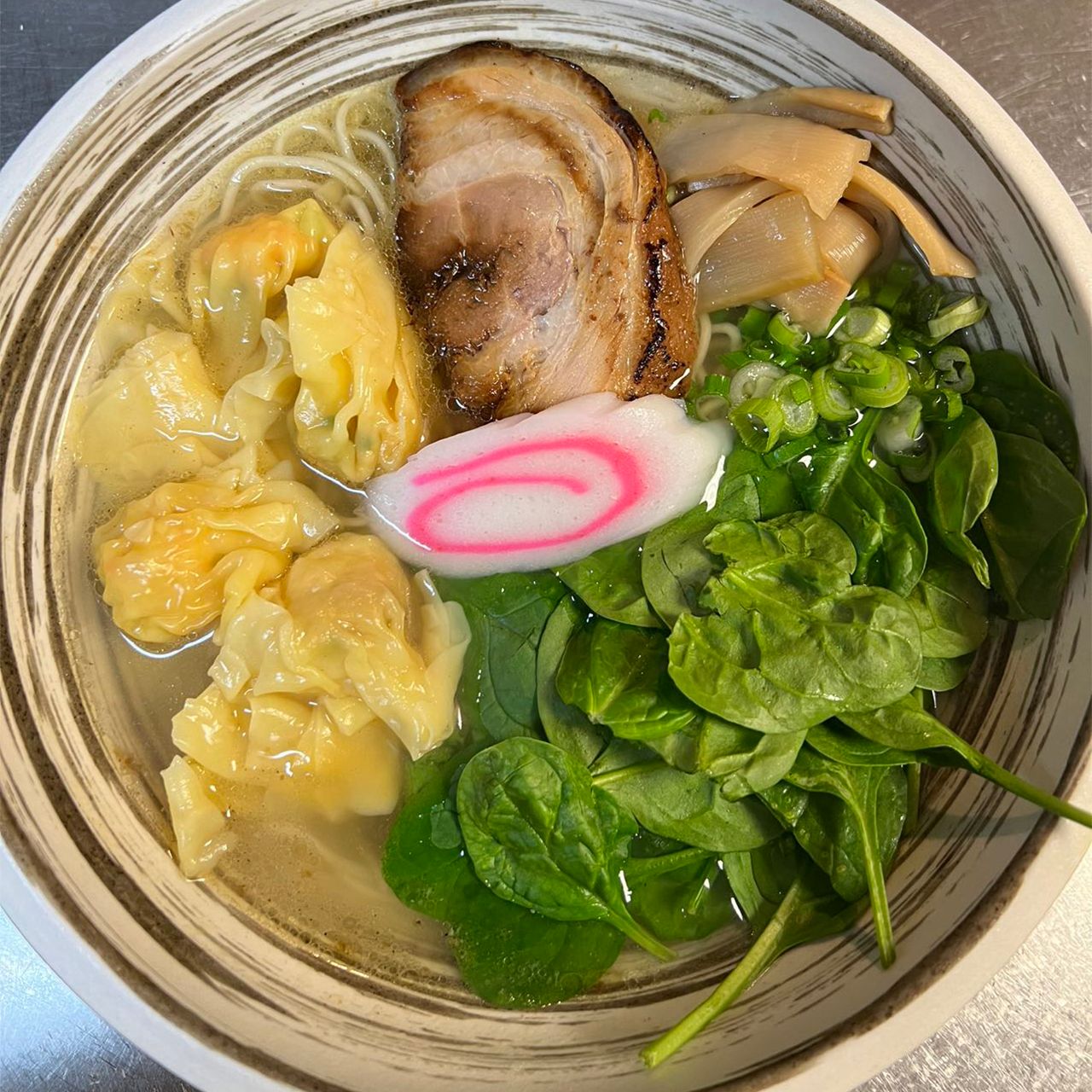 Light broth ramen with wontons, chashu pork, spinach and narutomaki fish cake