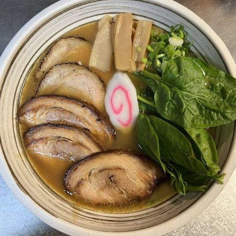 Miso ramen with sliced chashu pork, bamboo shoots, spinach and narutomaki