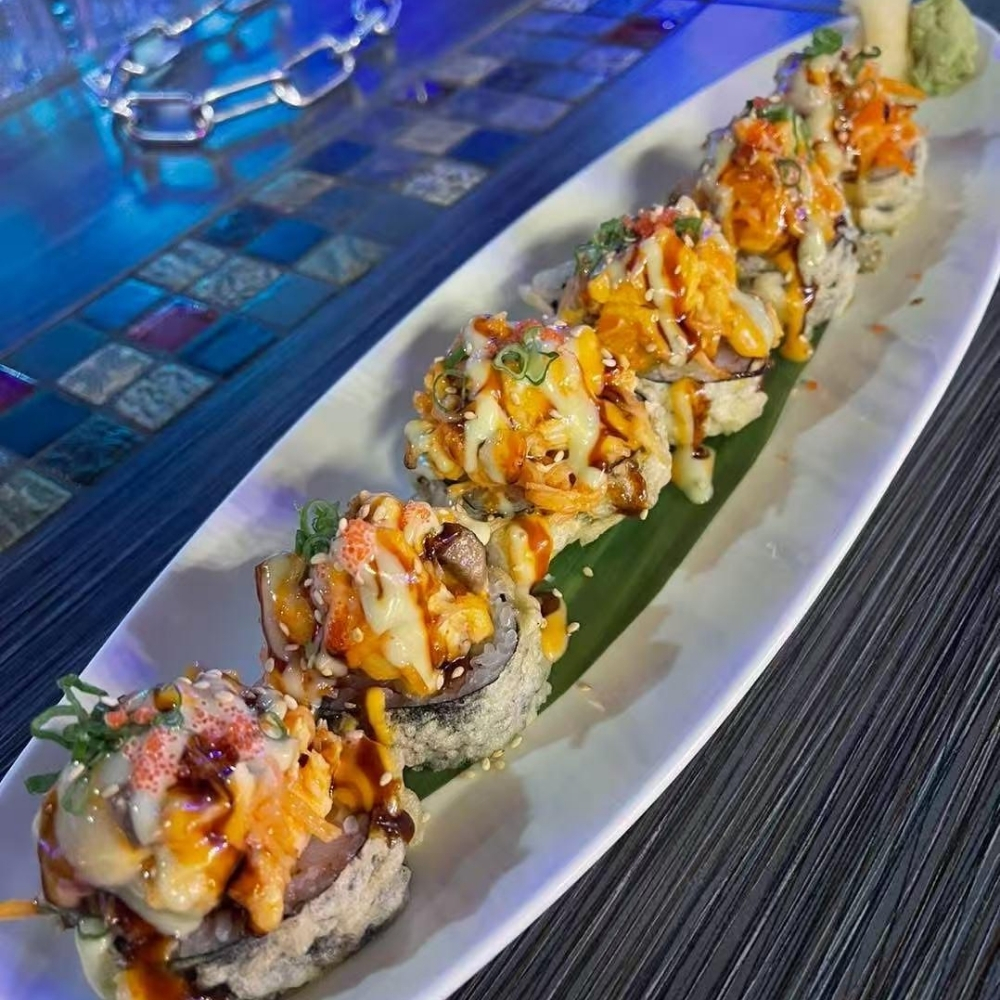 Creamy spicy sushi roll with sauces at Raku Sushi, a Japanese Restaurant in Easton
