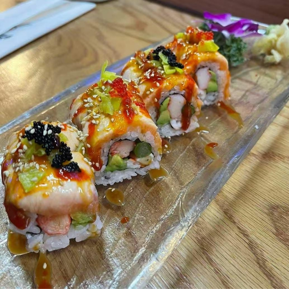 Eel-topped sushi roll with toppings at Raku Sushi, a Japanese Restaurant in Easton