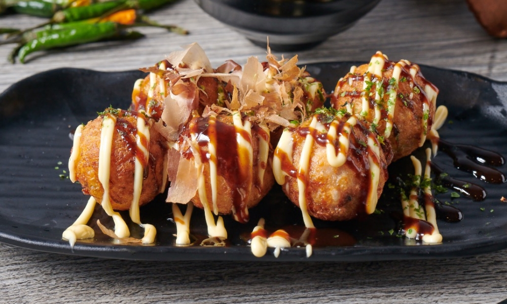 Delicious takoyaki with sauces and bonito flakes at RAMEN OSAKA, a Ramen Restaurant in San Jose