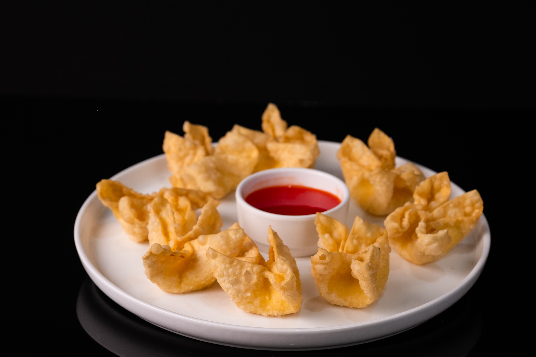 Crispy fried wontons with sweet and sour dipping sauce at Red Apple Buffet, a Buffet restaurant in Chicago