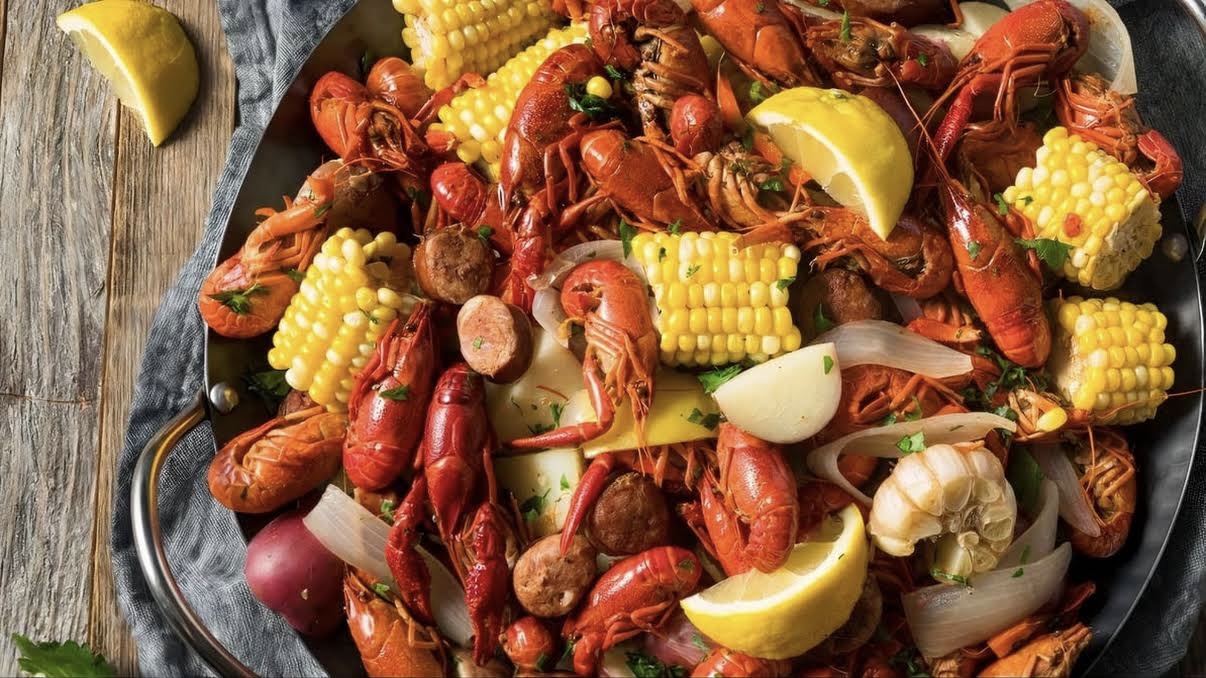 Crawfish boil platter with corn, potatoes, sausage, lemon, and garlic at Red Apple Buffet, a Buffet restaurant in Chicago