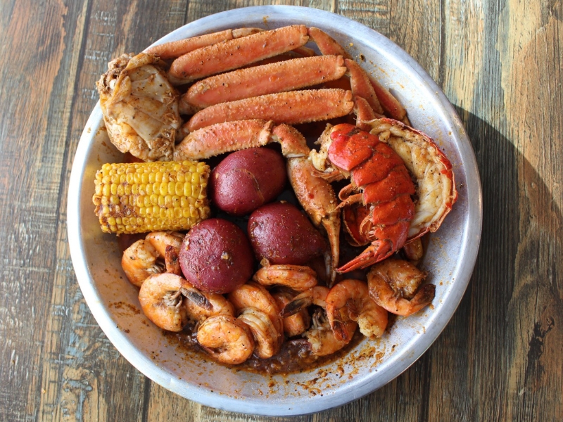 A seafood boil with lobster tail, crab legs, shrimp, corn and potatoes at Red Crab, an Seafood Restaurant in Melbourne