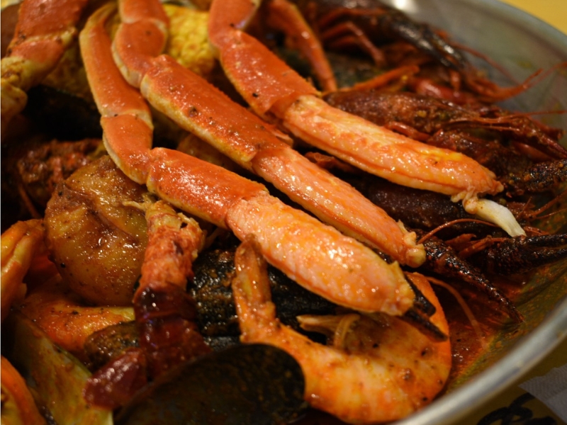 Close-up of crab legs, crawfish, shrimp and mussels in seafood boil at Red Crab, an Seafood Restaurant in Melbourne