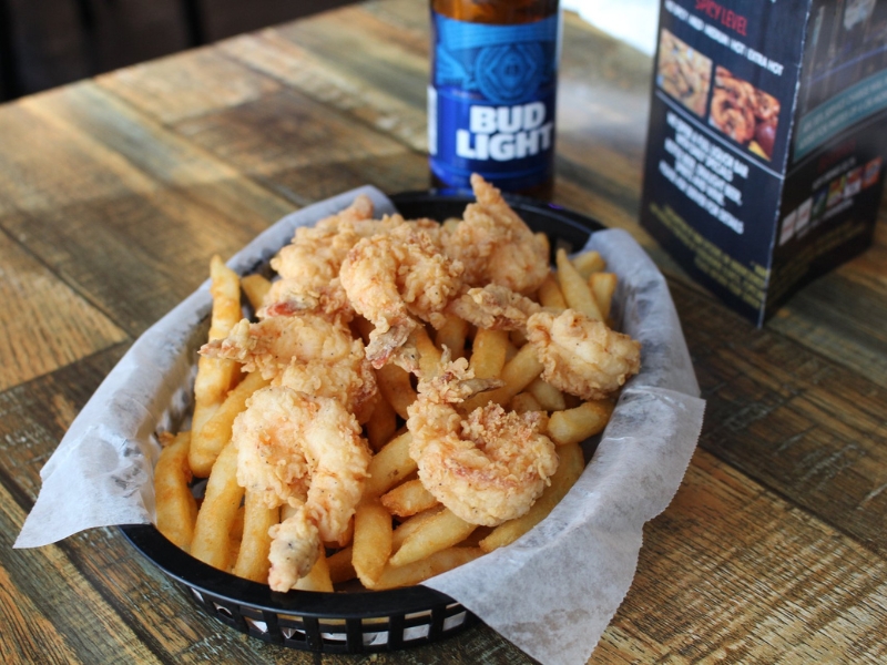 Fried shrimp with French fries served with a Bud Light beer at Red Crab, an Seafood Restaurant in Melbourne