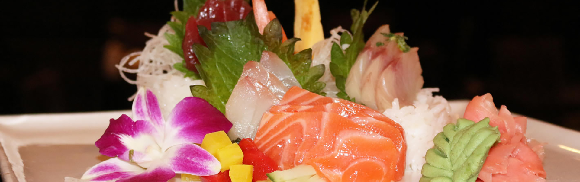 Premium mixed fresh sashimi garnished with orchid at Red Door Grill Asian Bistro Restaurant in Wainscott