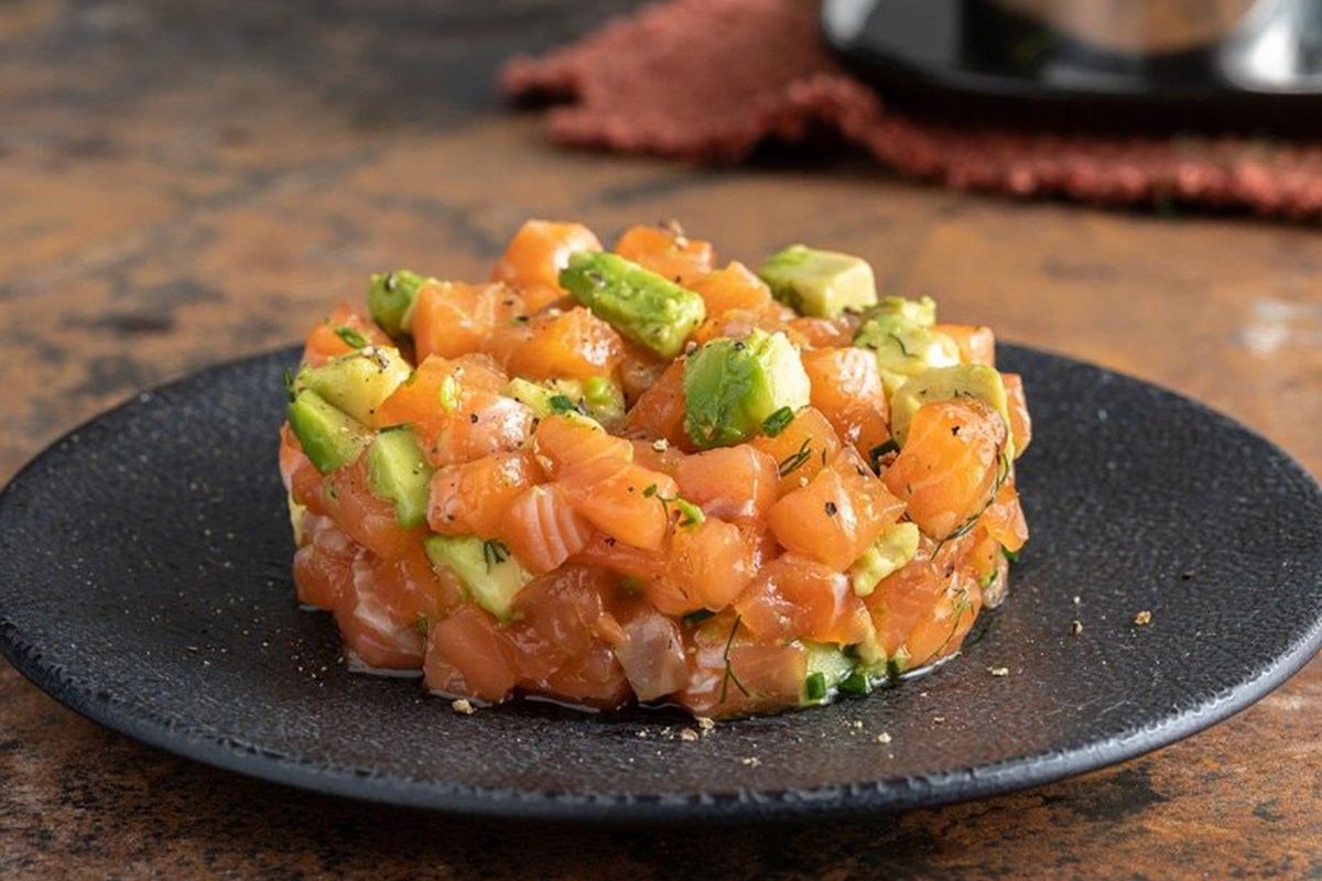 Salmon and avocado tartare on a black plate at Red Ginger Asian Bistro, an Asian Fusion Restaurant in Lake City